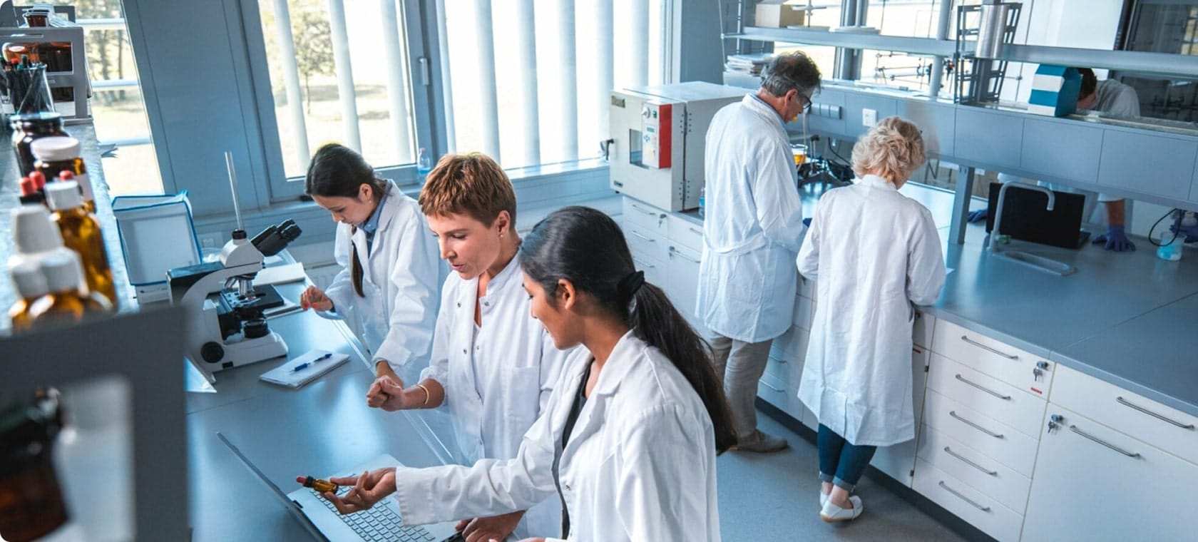 researcher-discussing-with-colleague-in-laboratory@2x